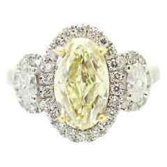 EGL Certfied Oval Fancy Light Yellow 2.02ct. Halo 3 Stone Ring Total Weight 3.09