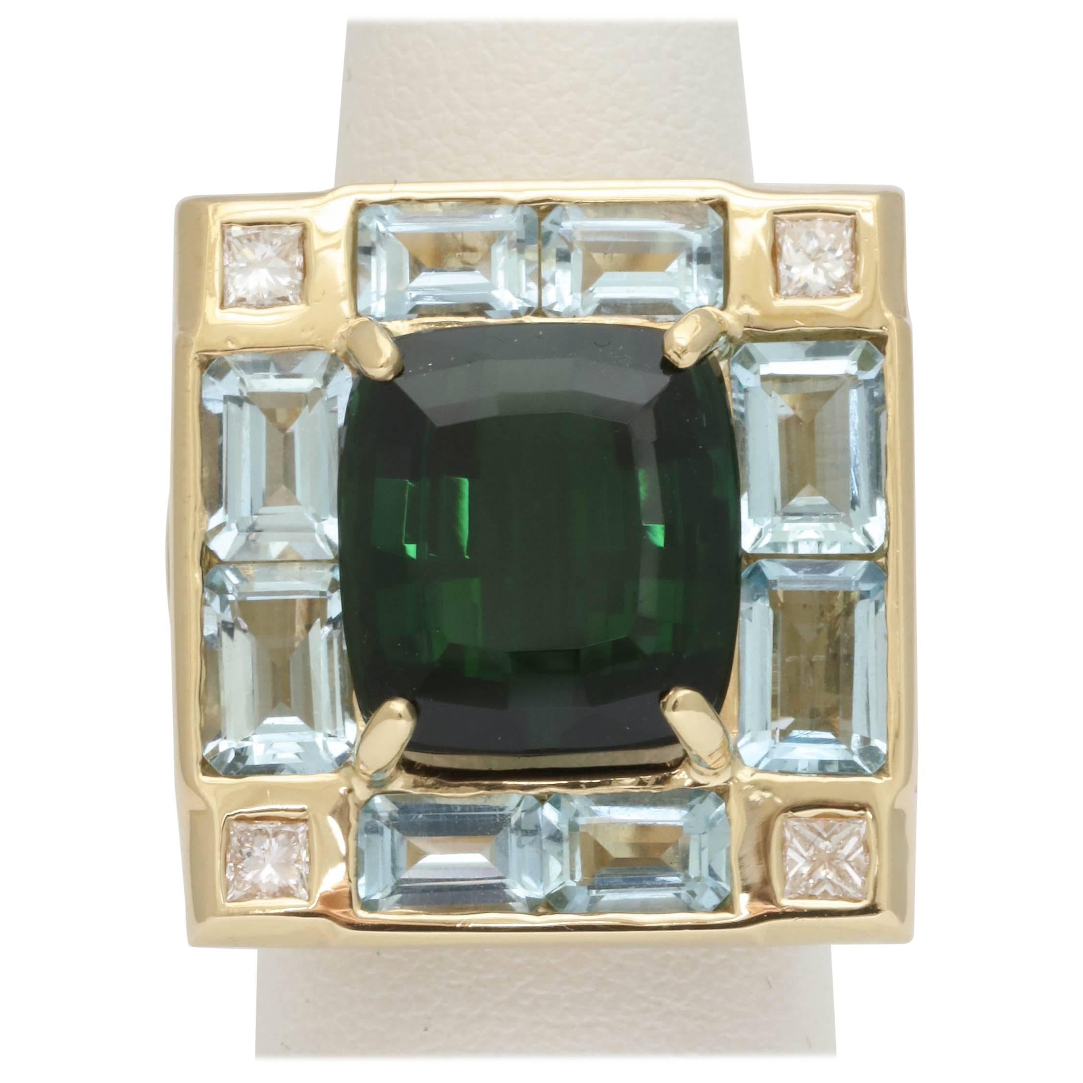 18kt yellow gold Large Cocktail Ring Consisting Of One 10 carat Beautiful Color Green Tourmaline Surrounded By 8 rectangular cut Aquamarines Weighing Approximately @ carats total weight anf further embellished with 4 full cut diamonds weighing .40