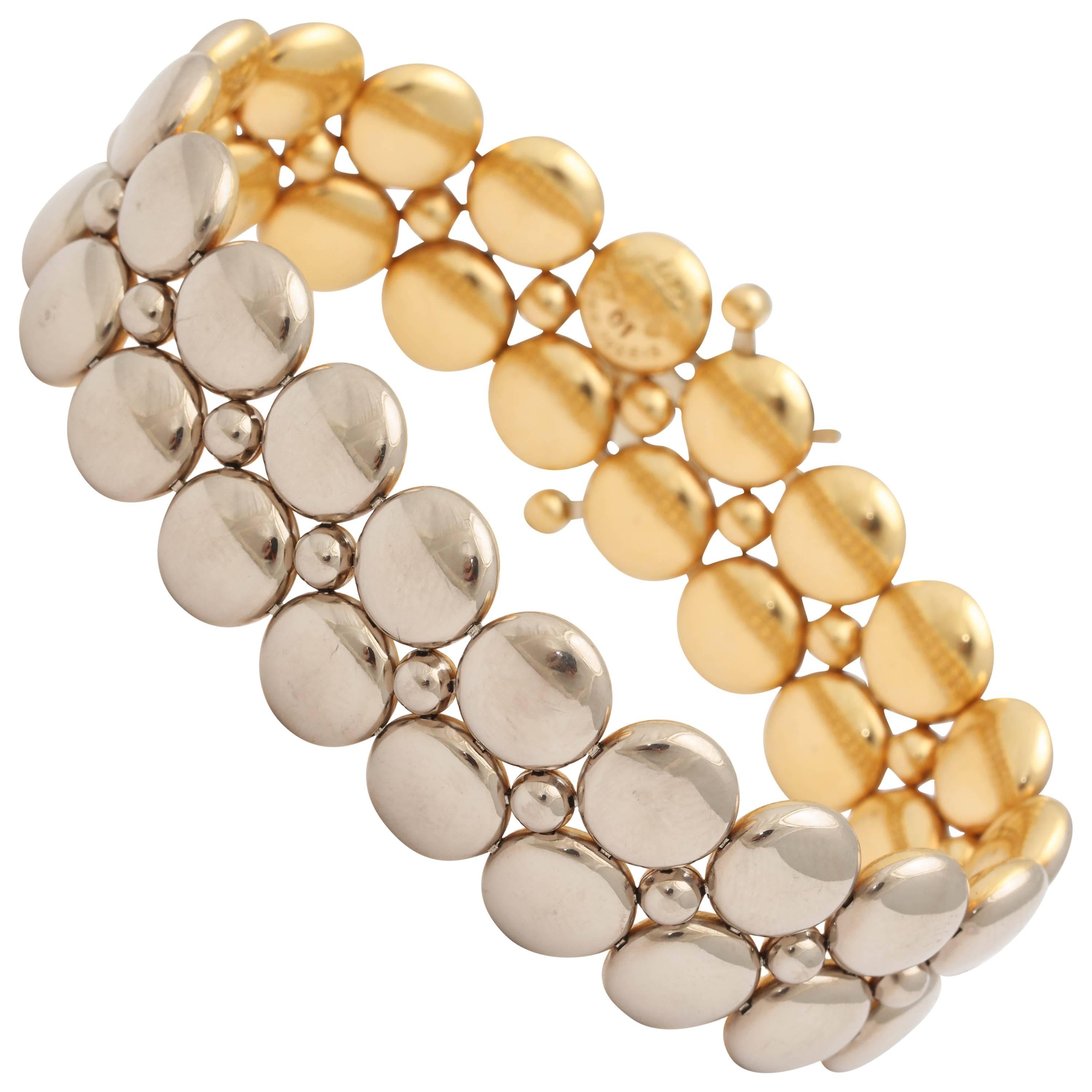 1980's Cartier Paris Reversible White And Yellow Gold Bracelet Consisting Of Numerous circle design templates. Note: May Be Worn on White Gold Side And Yellow Gold Side.