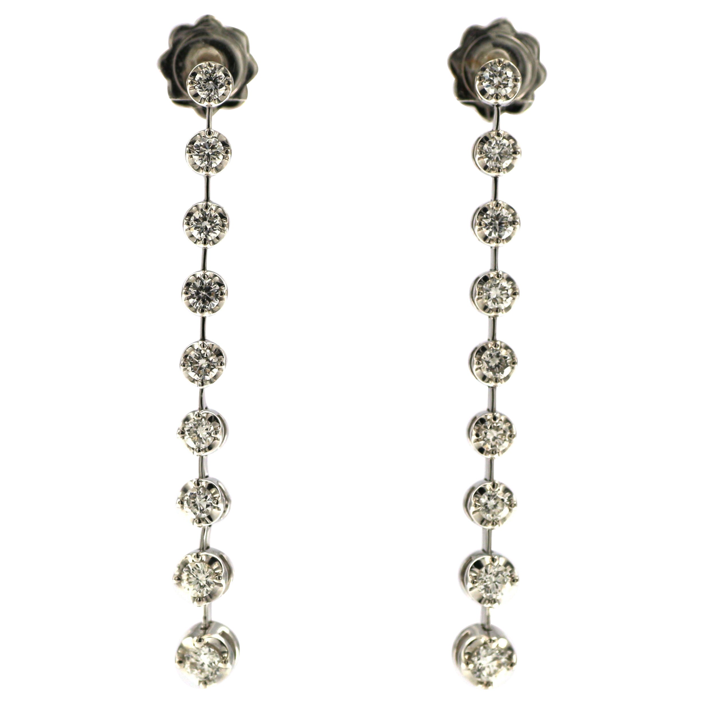 
These elegant diamond dangle drop earrings feature a cascade of round brilliant-cut diamonds, totaling approximately 0.95 carats. Each diamond is meticulously matched for size and set in a timeless bezel setting that enhances their individual