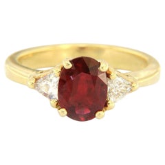 1.50ct Oval Ruby and 0.30ctw Trillion Diamond Three Stone Ring in 18K