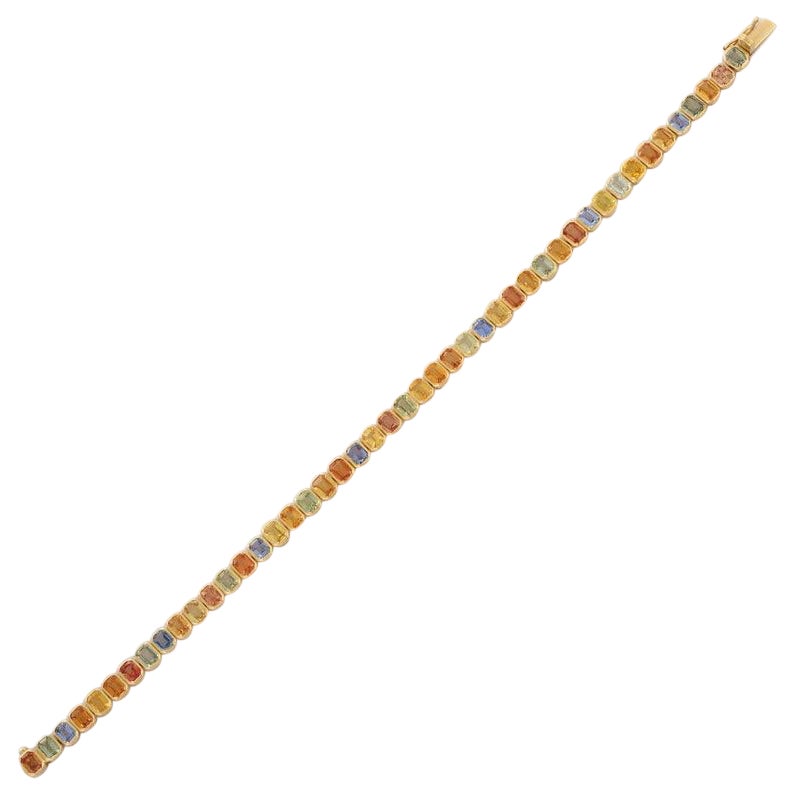 This Handcrafted Multi Sapphire Tennis Bracelet in 18K Gold showcases 46 endlessly sparkling natural sapphires, weighing 10.85 carats. It measures 7.5 inches long in length. 
Sapphire stimulates concentration and reduces stress. 
Designed with