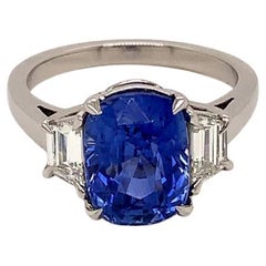 5.04 Carat Cushion cut Blue Sapphire and Diamond Three-Stone Ring in Platinum