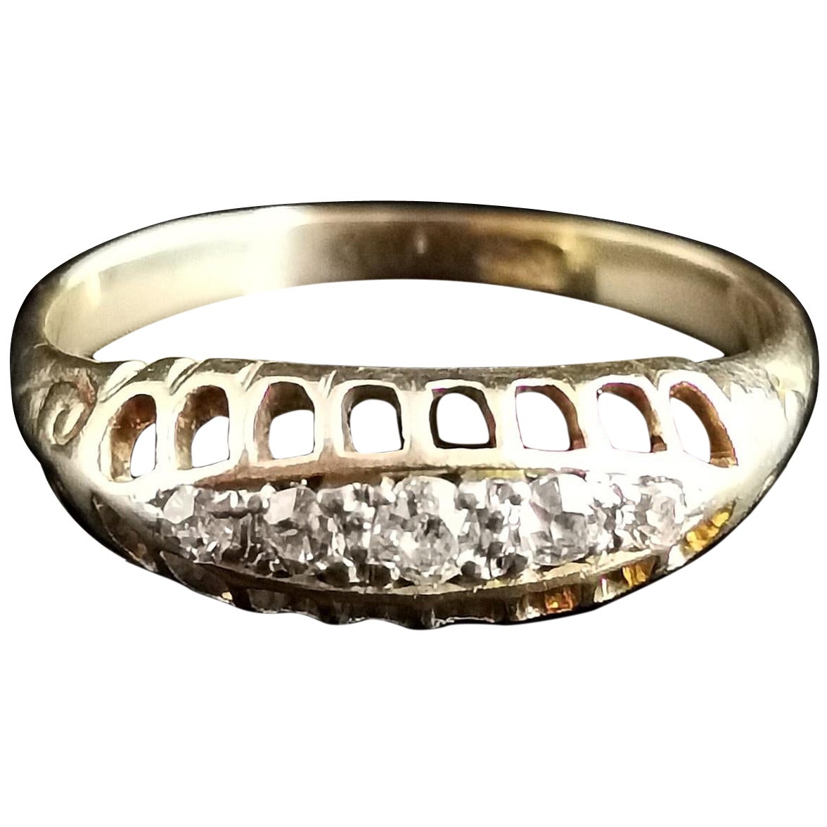 A beautiful antique five stone diamond ring.

It is a boat head style ring claw set with six individual old cut diamonds which graduate in size, the centre stone being the largest.

It has a rich smooth 18 karat yellow gold band.

The shoulders are