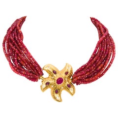 18 Karat Yellow Gold Ruby and Diamond Starfish 12 Strand Faceted Ruby Beads