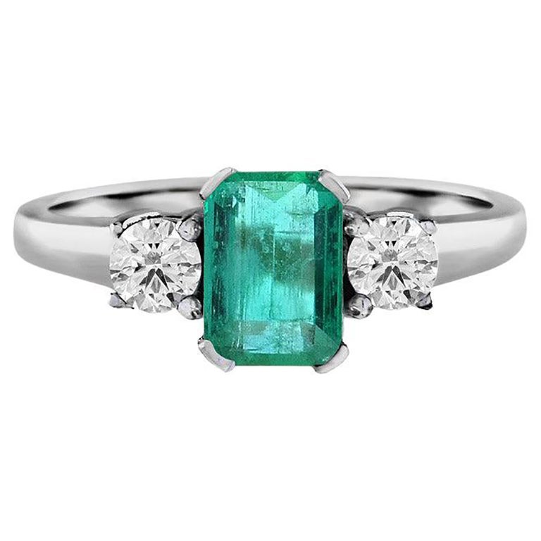 Emerald Cut Emerald and Round Diamond Solitaire Ring in 18k White Gold