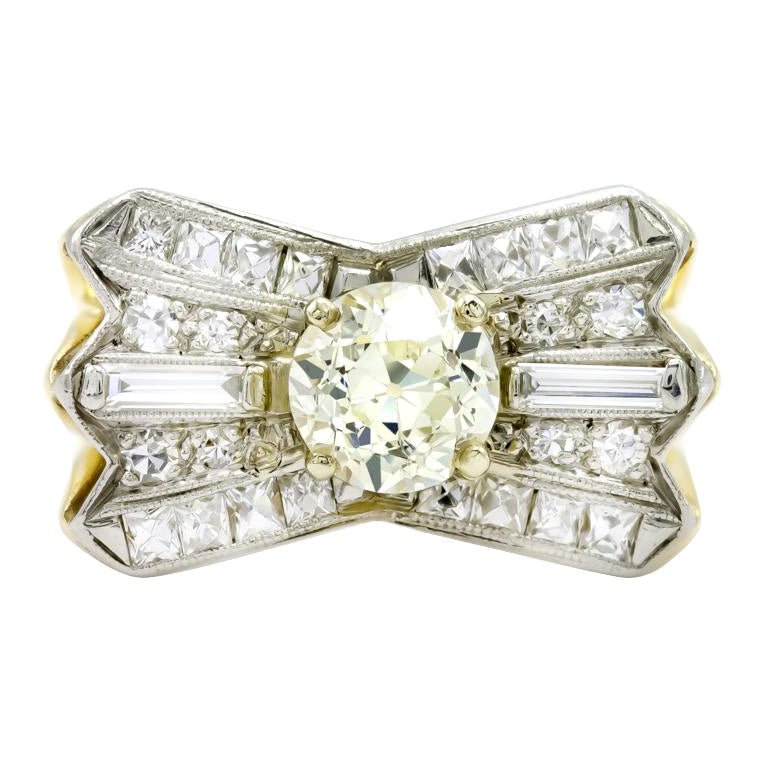 A chunky diamond, chunky setting and that rich yellow gold. We love this statement ring for so many reasons. Like the knot of a bow, a juicy 1.23 carat old Euro with a hint of color catches the light and truly dances. With a complimenting sea of