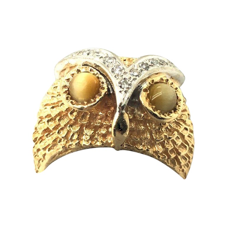 An owl is thought to be a symbol of wisdom and knowledge. What a fun way to wear it as a ring. This whimsical owl ring features two cabochon tiger's eyes Chalcedony and diamond accent. The total weight of diamond is approximately 0.25 carat. The