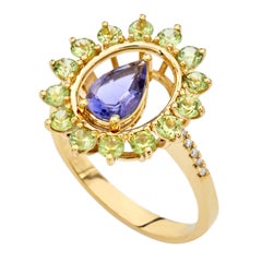 Ring in 18kt Yellow Gold Pear Iolite Peridots and Diamonds Oval Shape Cluster