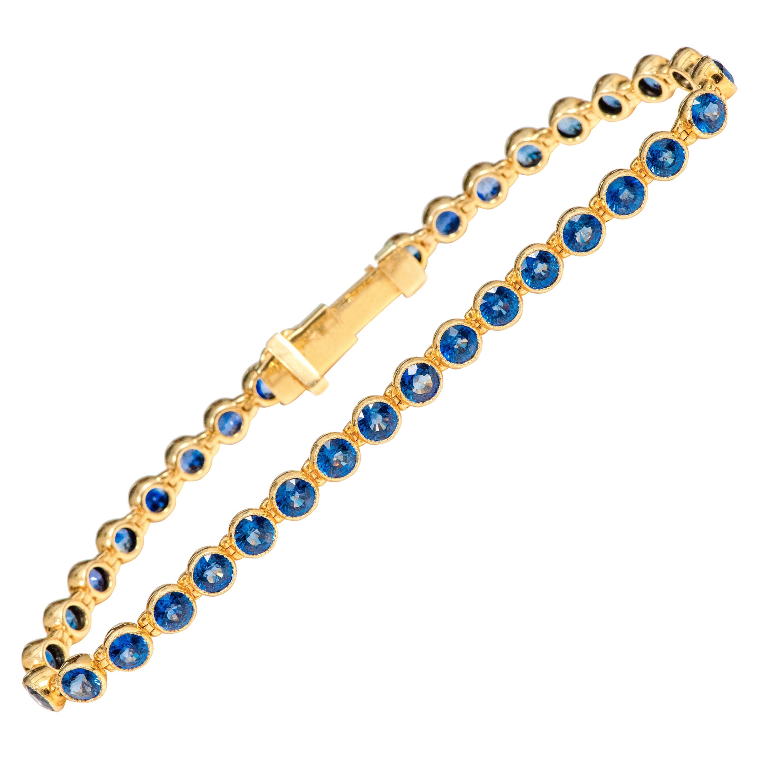 18 Karat Yellow Gold 11.72 Carat Blue Sapphire Tennis Bracelet in Bezel Setting