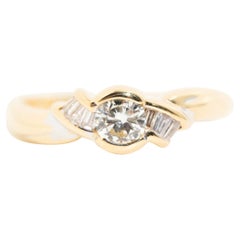 Round Brilliant and Baguette Diamond Engagement Ring in 18 Carat Yellow Gold