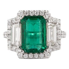 Alexander 4.48 Carat Emerald with Diamond Three Stone Halo Ring 18 Karat Gold