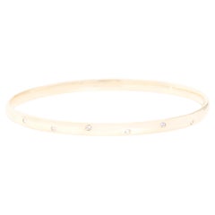 Round Brilliant Diamond Hammer Set Solid Oval Bangle in 9 Carat Yellow Gold