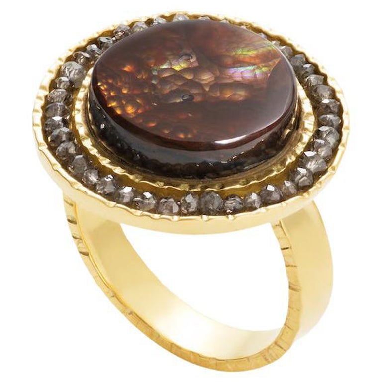 18KY, Fire Agate (9.5 CTW)  surrounded by Brown Diamonds give this unique, one-o-a-kind ring an eye catching quality.
The semi transparent swirling colors of the Fire Agate are quite mesmerizing, highlighted by a halo of Brown Diamonds set in 18KY