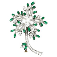 18Kt White Gold Flower Brooch with 2.94 Ct Diamonds and 1.60 Ct Emeralds