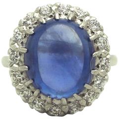 Anello a grappolo in platino con zaffiro blu cabochon e diamante
