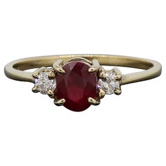 Oval Ruby and Diamond Three-Stone Ring 9 Karat Yellow Gold