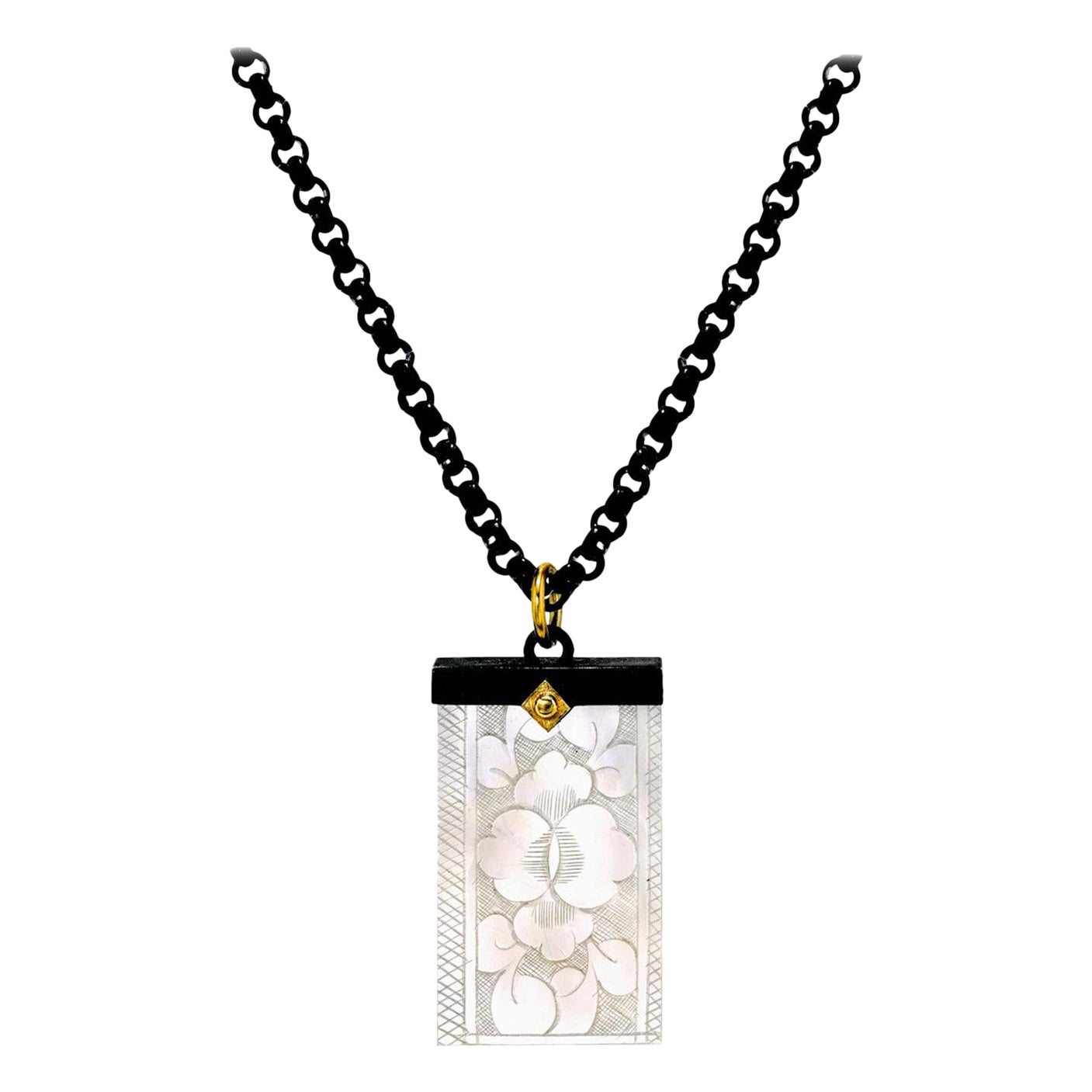 This necklace features an antique mother-of-pearl gaming counter that was carved in China for export to Britain during the late 1700's-early 1800's. The British used these beautiful counters to play games and gamble with. (Please refer to the