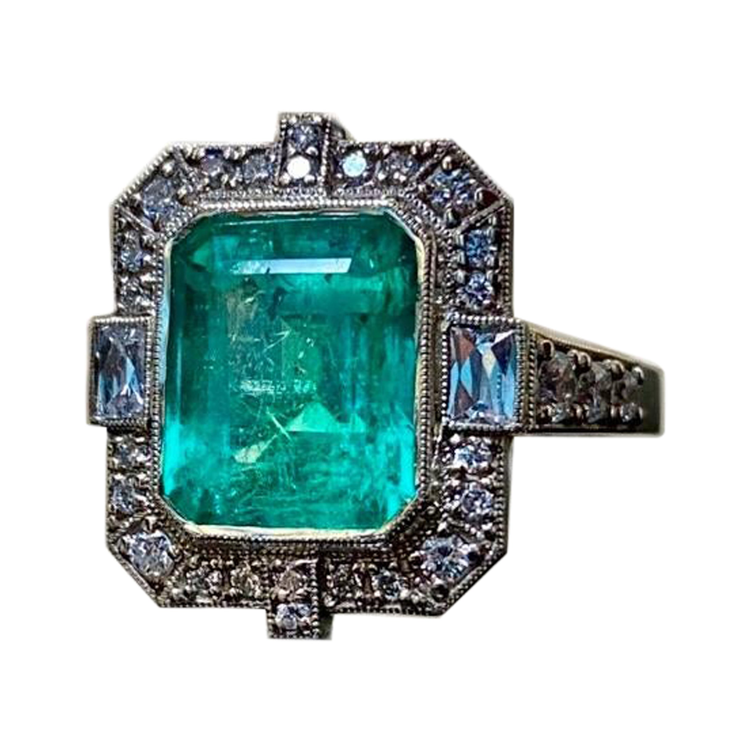 DeKara Designs Collection

Metal- 14K White Gold, .583.

Stones- 1 GIA Certified 4.60 Carat Colombian Emerald, Two Specially French Cut Damonds, 30 Round Diamonds F-G Color VS2 Clarity 0.97 Carats.

GIA Report Number 6224040218

Handmade Art Deco