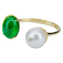 Used Emerald and Pearl 14k gold ring. Adjustable emerald ring