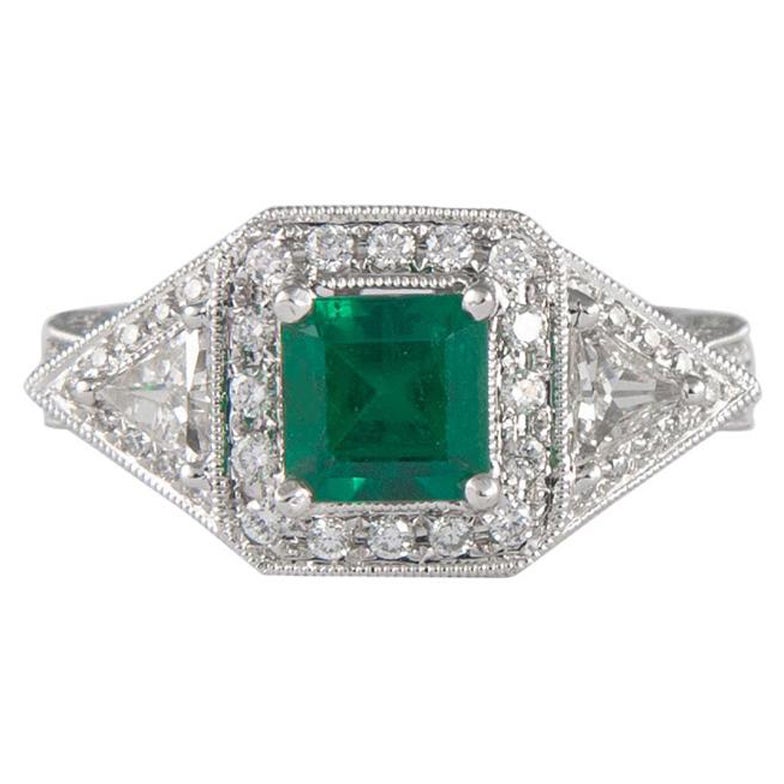 1.08 Carat Emerald Three-Stone Diamond with Halo Ring 18 Karat Gold For Sale