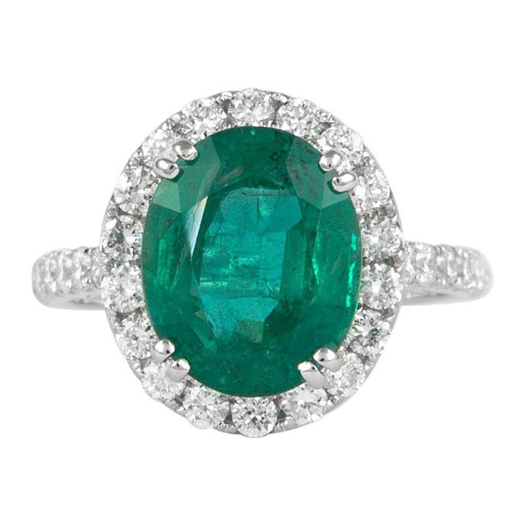 Alexander 4.05 Carat Emerald with Diamond Halo Ring 18 Karat White Gold For Sale