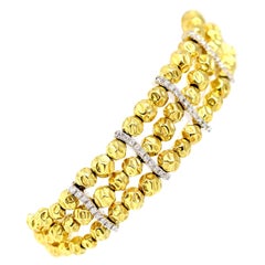 An Italian Hammered Gold Beads Bracelet with diamonds 18k
