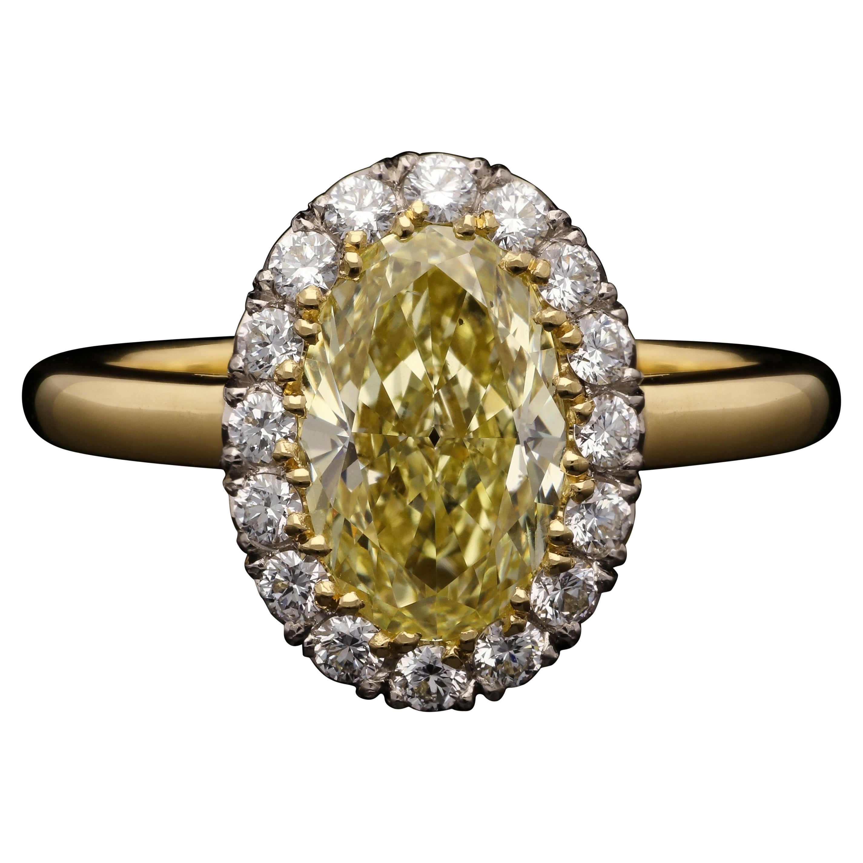 Hancocks 1.54ct Fancy Yellow Oval Diamond Cluster Ring with Diamond Surround For Sale