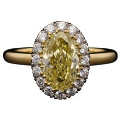 Hancocks 1.54ct Fancy Yellow Oval Diamond Cluster Ring with Diamond Surround