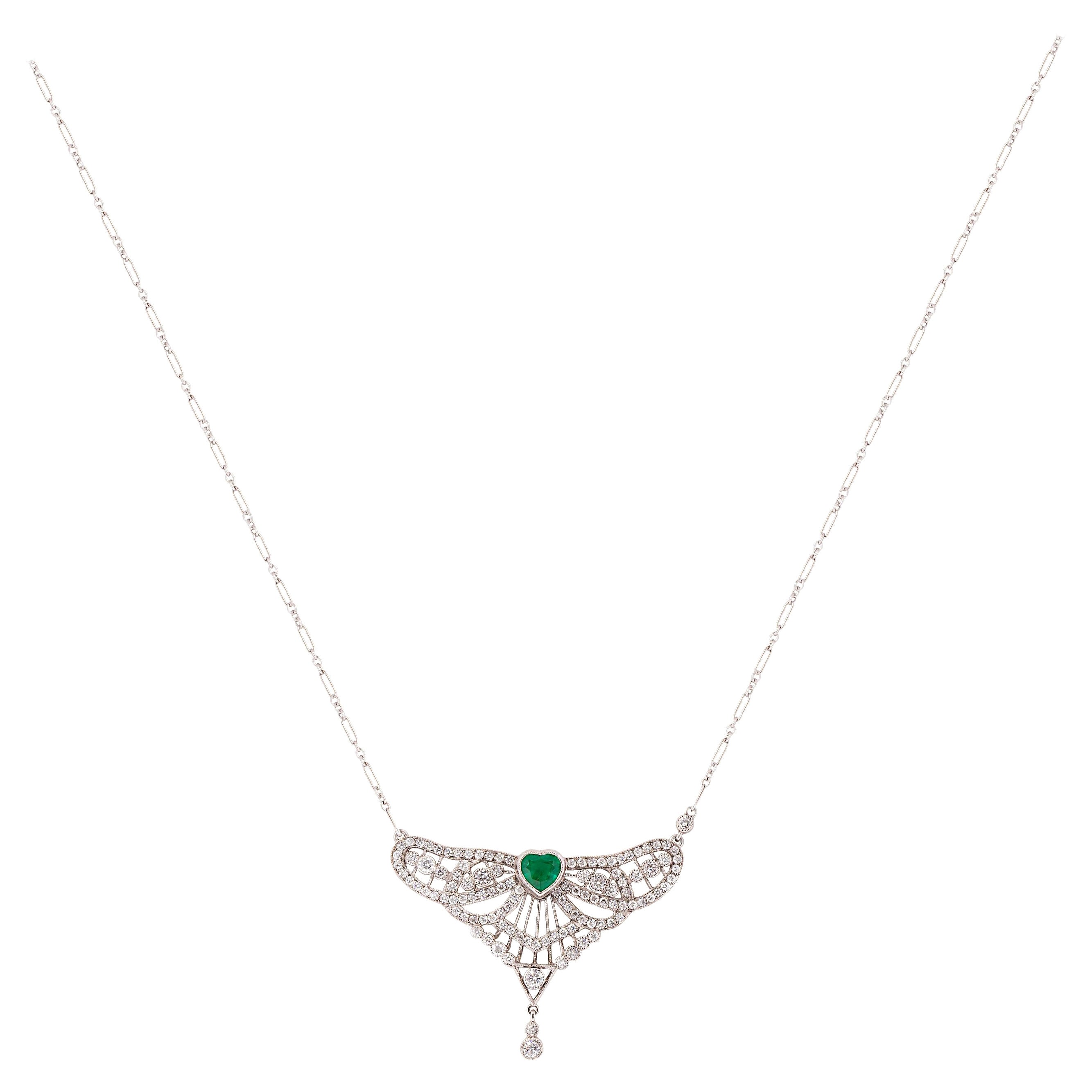 Inspired by beautiful lines and symmetry of Art Deco Era, this pendant necklace centers a 0.81 carat heart shaped emerald. The deep green emerald is accentuated by 112 round brilliant diamonds weighing 1.44 carat total weight and exquisite detail of