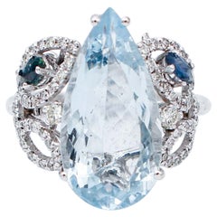 Anello con acquamarina, zaffiri, diamanti, oro bianco 14 carati
