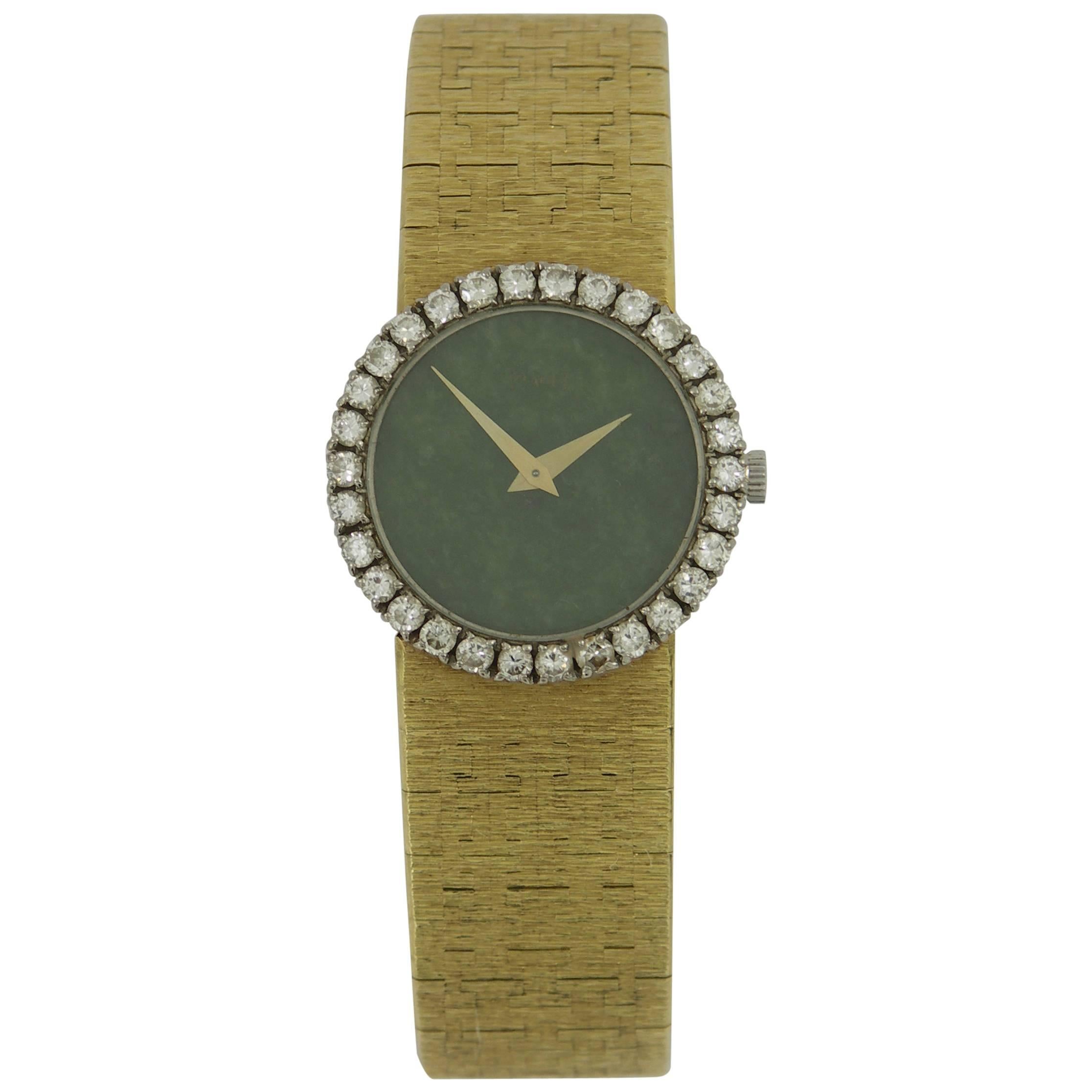 One ladies Piaget wristwatch, with 30 round brilliant cut diamonds, set into the bezel, for a total weight of approximately 1.25ct. The watch also features a rich, green, jade dial. 
Inside circumference is six inches.