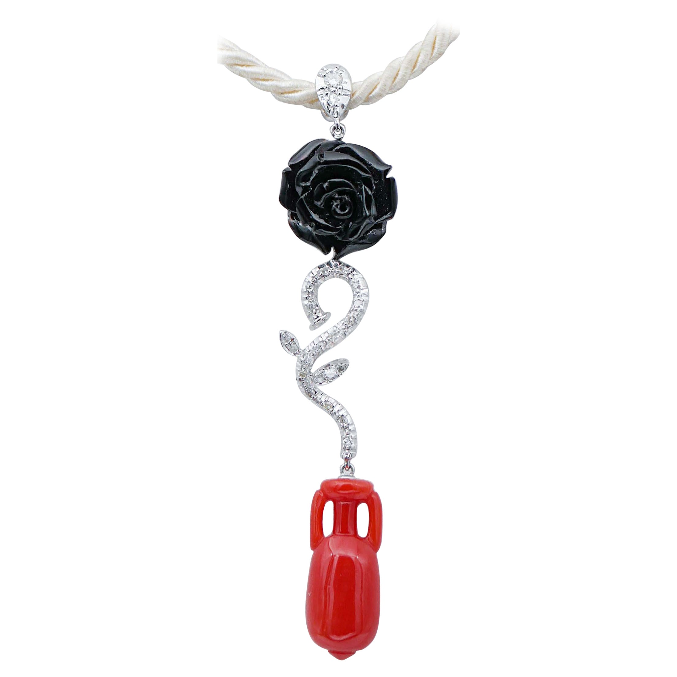 Collier à pendentifs en corail noir et rouge, diamants, or blanc 14 carats.