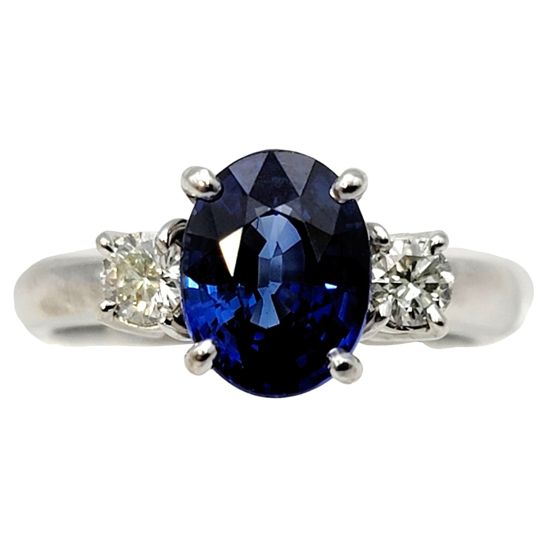 2.19 Carats Total Oval Natural Blue Sapphire and Round Diamond Three Stone Ring For Sale