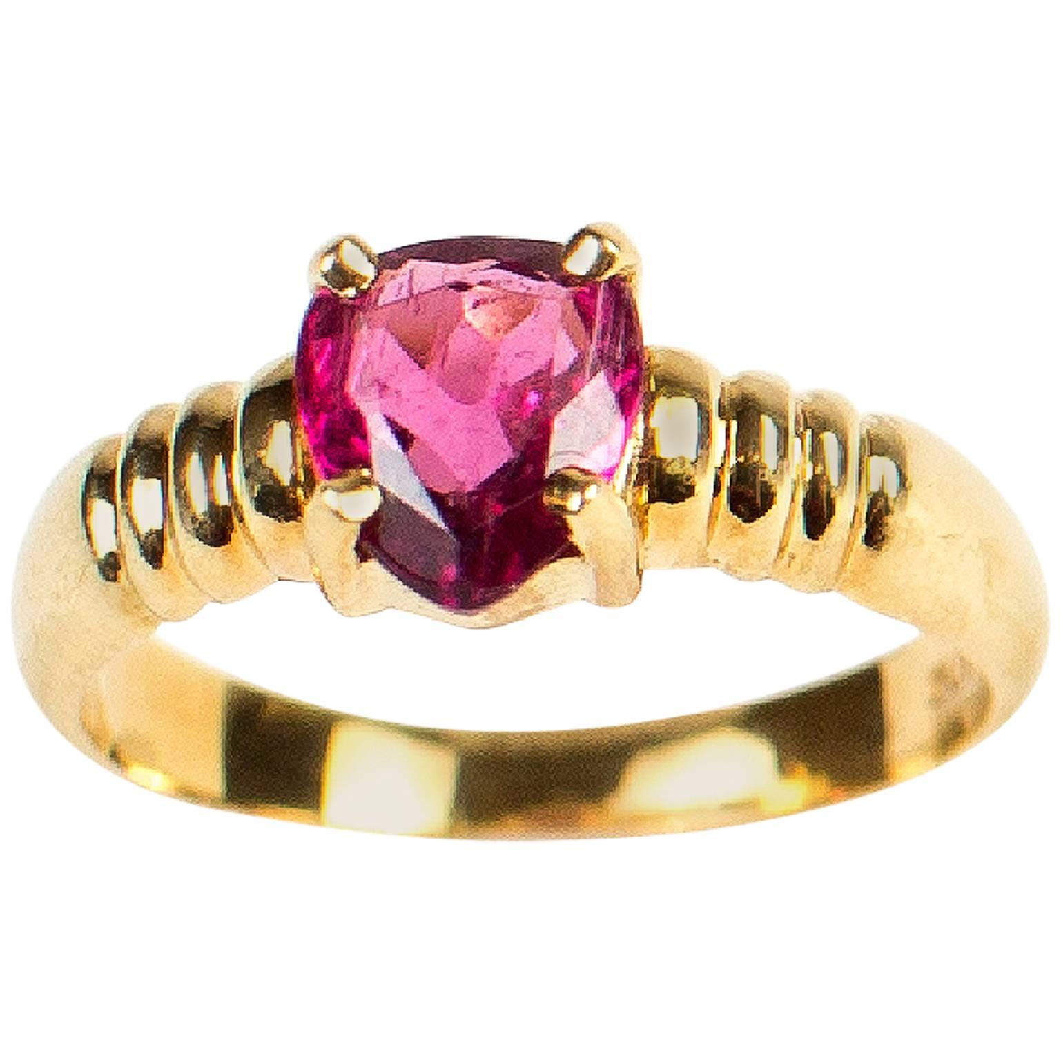 Lovely Pear shape (approximately 8x6mm) sparkling Brazilian Rubelite set a  Brazilian handmade18kt yellow gold ring.  The ring (shank)  itself has just the right amount of detail to enhance the rubelite and is of a nice weight.
Size 6.5.  
