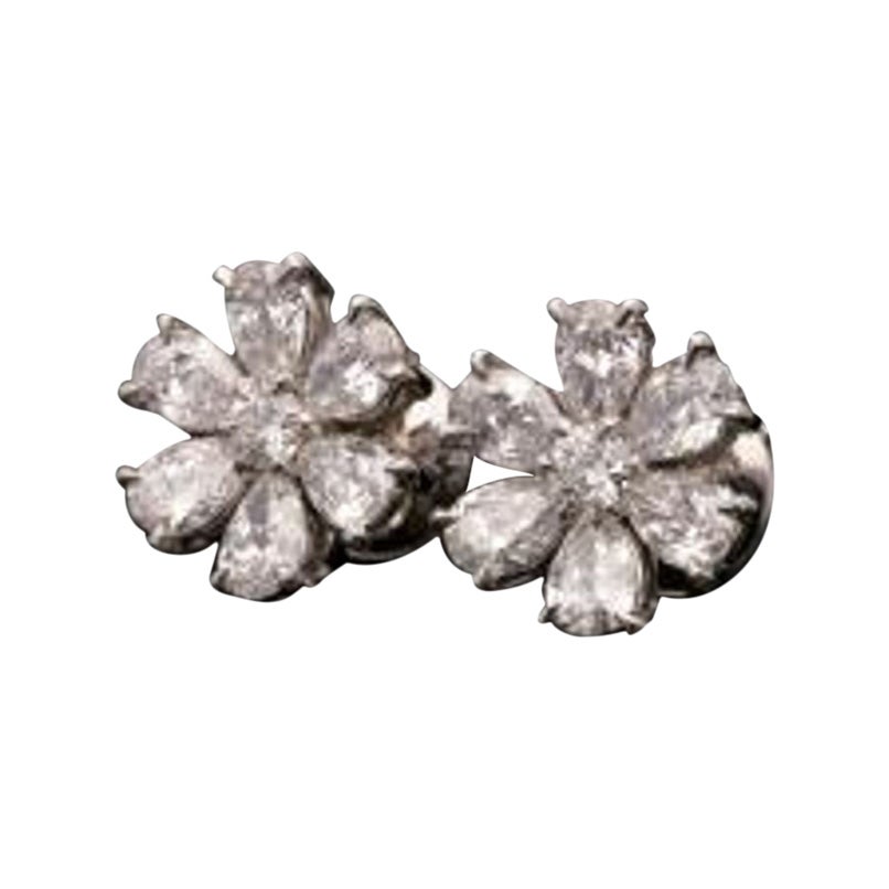 Hancocks Beautiful pair of platinum and pear-shaped diamond flower head earrings For Sale