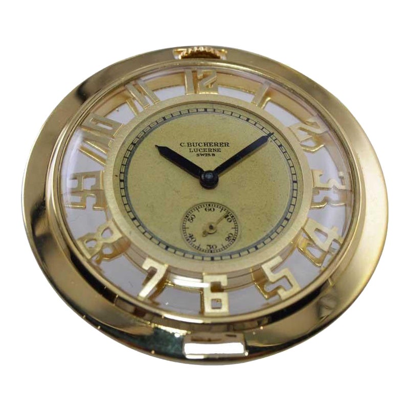 FACTORY / HOUSE: C. Bucherer Jewelers
STYLE / REFERENCE: Open Faced Pocket Watch
METAL / MATERIAL: 14Kt. Solid Gold
CIRCA / YEAR: 1930's
DIMENSIONS / SIZE: Diameter 45mm
MOVEMENT / CALIBER: Manual Winding / 15 Jewels 
DIAL / HANDS: Original Gilt