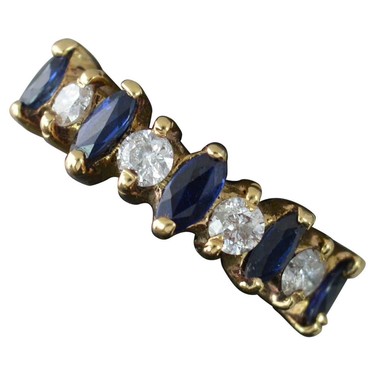 18 Carat Gold Marquise Blue Sapphire and Round Cut Diamond Half Eternity Ring