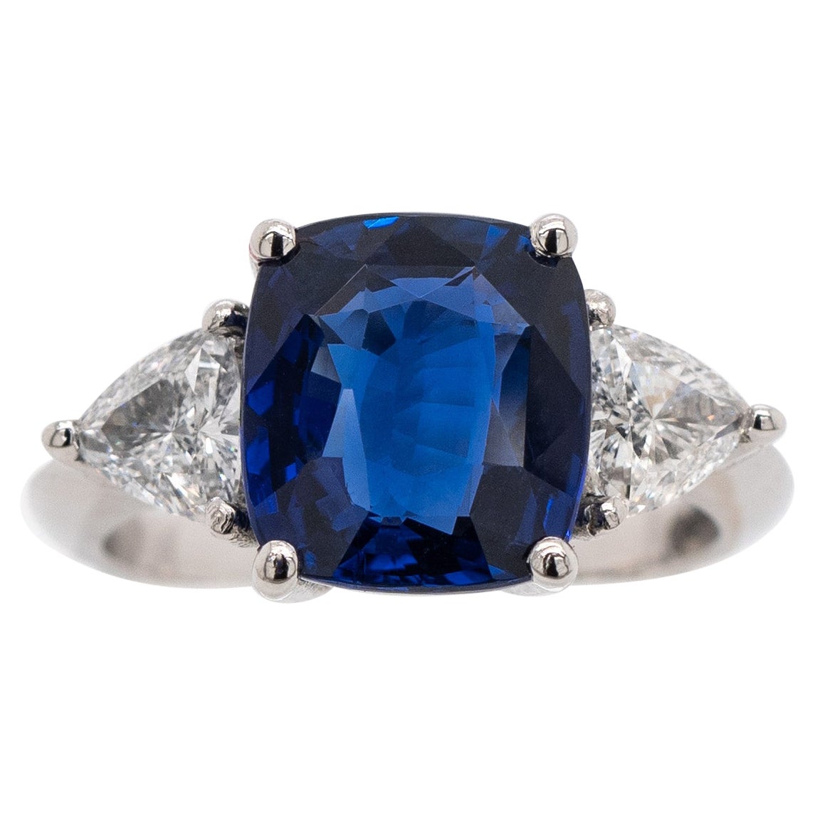 Material: Platinum
Ring Size: K 1/2
Total Ring Weight: 6.9g
Sapphire Weight: 4.05ct
Rubellite Shape: Rectangular Cushion Brilliant Mixed
Sapphire Colour: Royal Blue
Total Diamond Weight: 1.34ct (2x0.67ct)
Diamond Shape: Trillion
Diamond