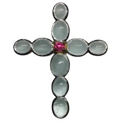 A Silver Cross Pendant set with Milky Aquamarine & an Unheated Pink Sapphire.