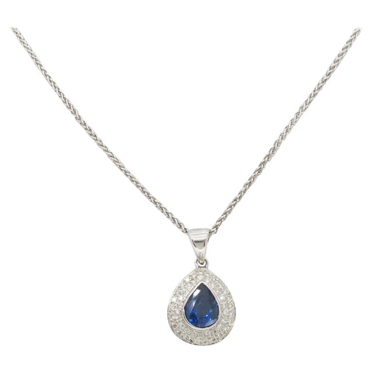 Blue Sapphire and Diamond Halo Pendant Necklace in 18k For Sale at 1stDibs