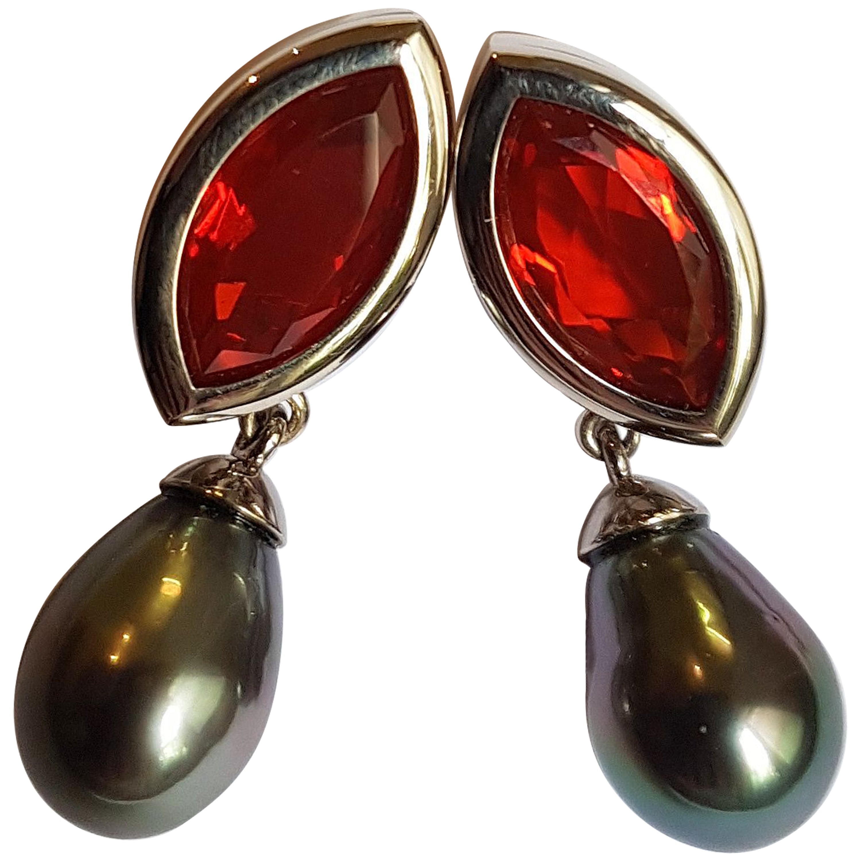 Dazzling earrings made of white gold, one each mexican fire opal navette with a total of 7.51 carats 
(17,2 x 9,1 x 4,5 mm / 0.68 x 0.36 x 0.18 inches) and one each tahiti-pearl drop with outstanding luster.
The radiant sparkling fire opals