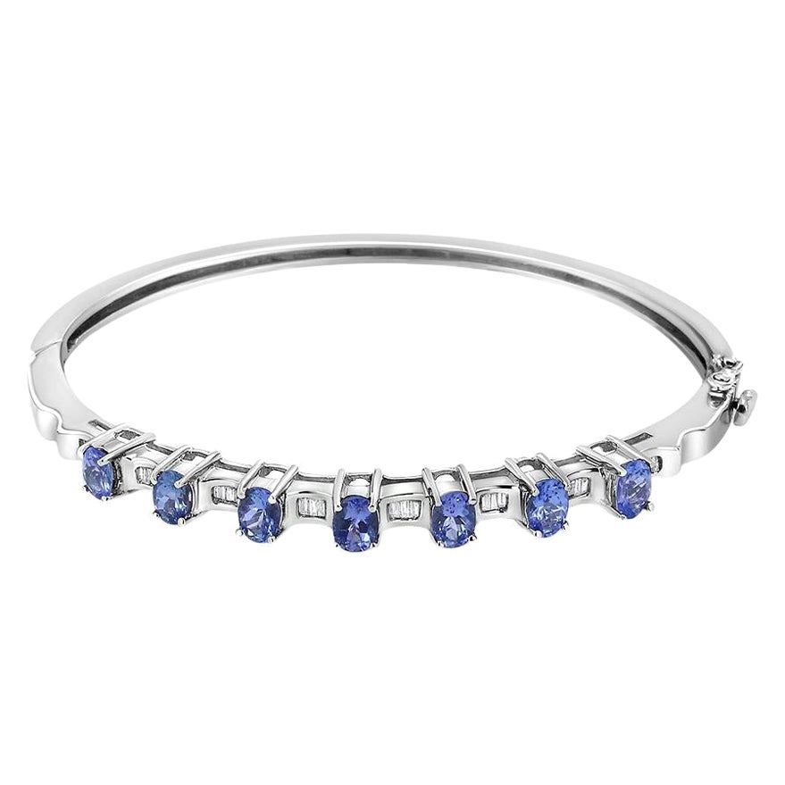 Bracelet jonc en or blanc 14 carats avec tanzanite bleue ovale et diamants 1/4 carat