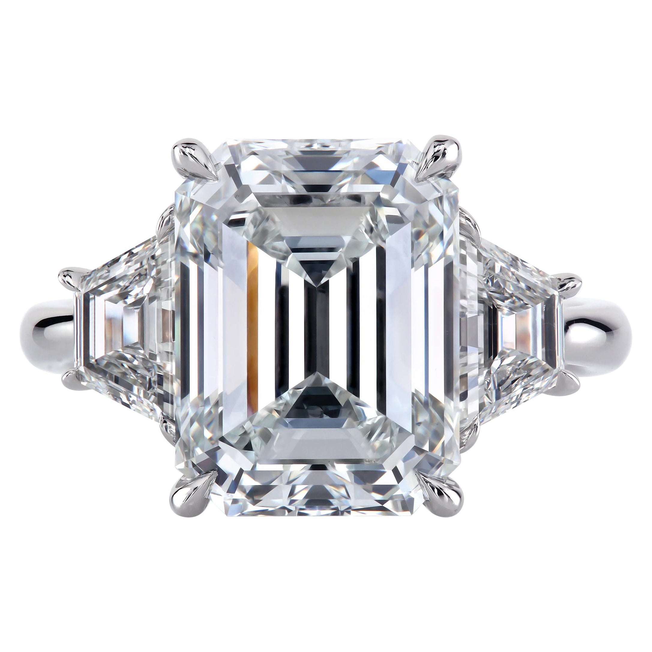 Bespoke three-stone ring with an emerald-cut diamond and a pair of matching step-cut trapezoid diamonds.
All fine details of the design will be discussed before any work begins. The price is inclusive of the GIA-certified 3.01 ct G/ VS1 emerald cut