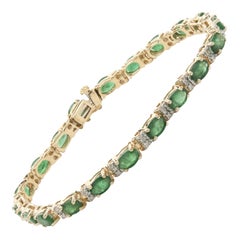 14 Karat Yellow Gold Oval Emerald and Diamond Inline Tennis Bracelet