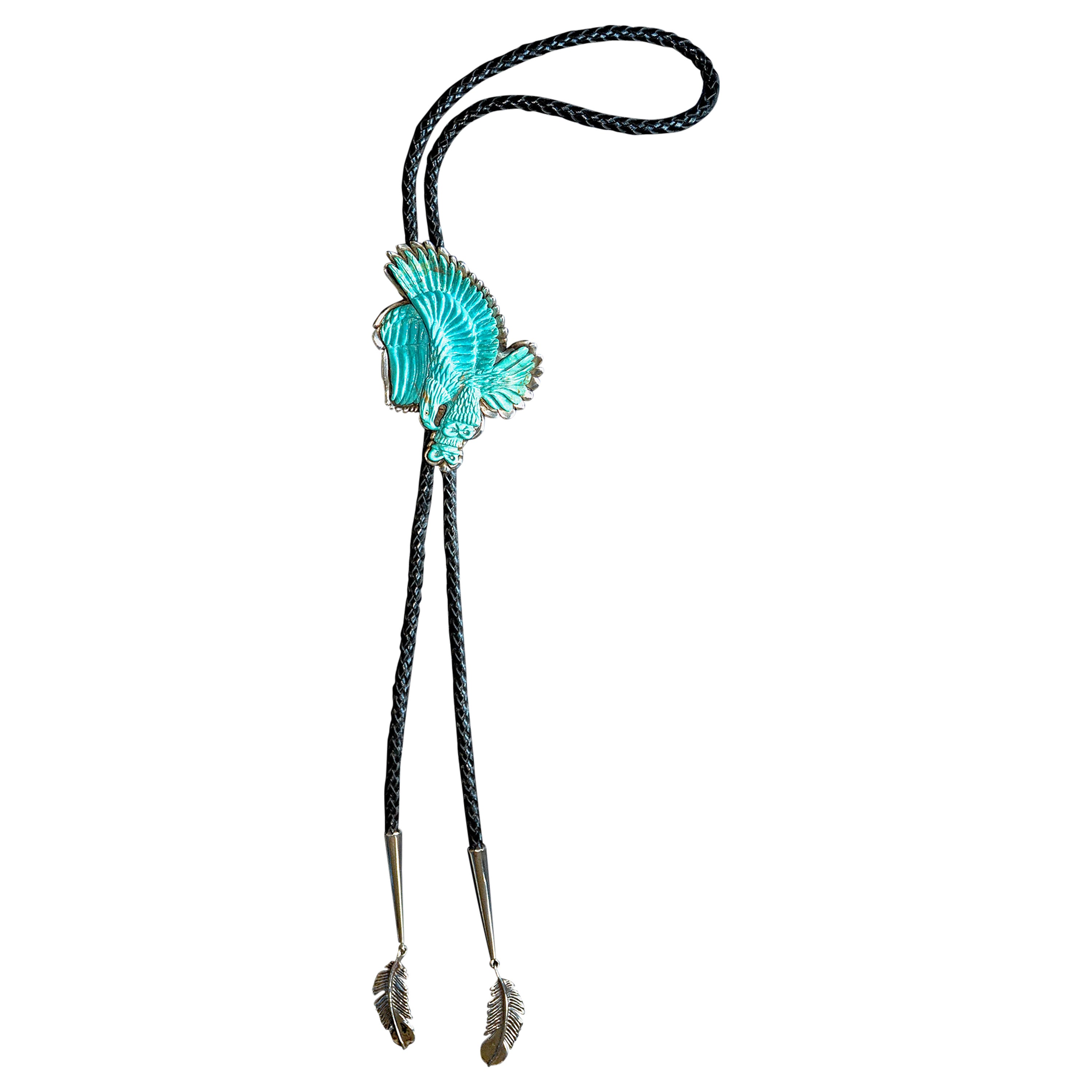 A unique carved Kingman-Mine Turquoise Eagle and Sterling Silver Bolo Tie by John Winston.

An exquisitely and richly relief-carved 380 carat turquoise eagle in flight is set in 6 ounces of sterling silver. It has an adjustable black braided-leather