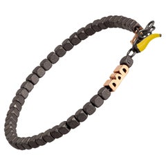 Bracciale da uomo in titanio, linea Cuby, papà in oro rosso 9KT e corno giallo portafortuna