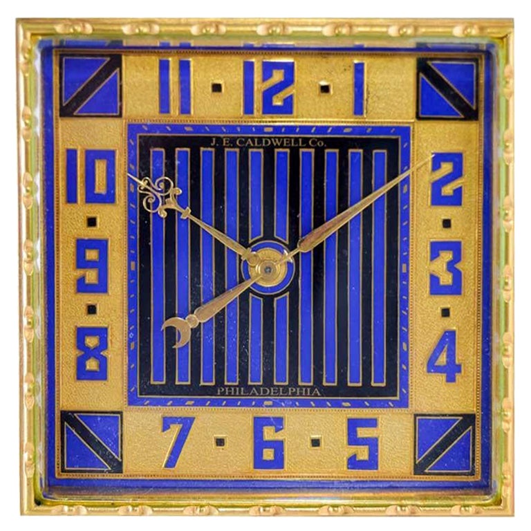 FACTORY / HOUSE: J. E. Caldwell
STYLE / REFERENCE: Art Deco
METAL / MATERIAL: Gilded Finish with Kiln Fired Enamel Inlay
CIRCA / YEAR: 1930's
DIMENSIONS / SIZE: 4 Inches X 4 Inch X 2 Inch Angle
MOVEMENT / CALIBER: Manual Winding / 15 Jewels 
DIAL /