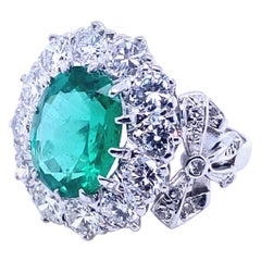 Retro 4.15 Carat Zambian Emerald and Diamond Cluster 18 Kt White Gold Engagement Ring