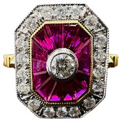 Engagement Ring in 18 Carat Gold Set with Calibrated Rubies and Diamonds